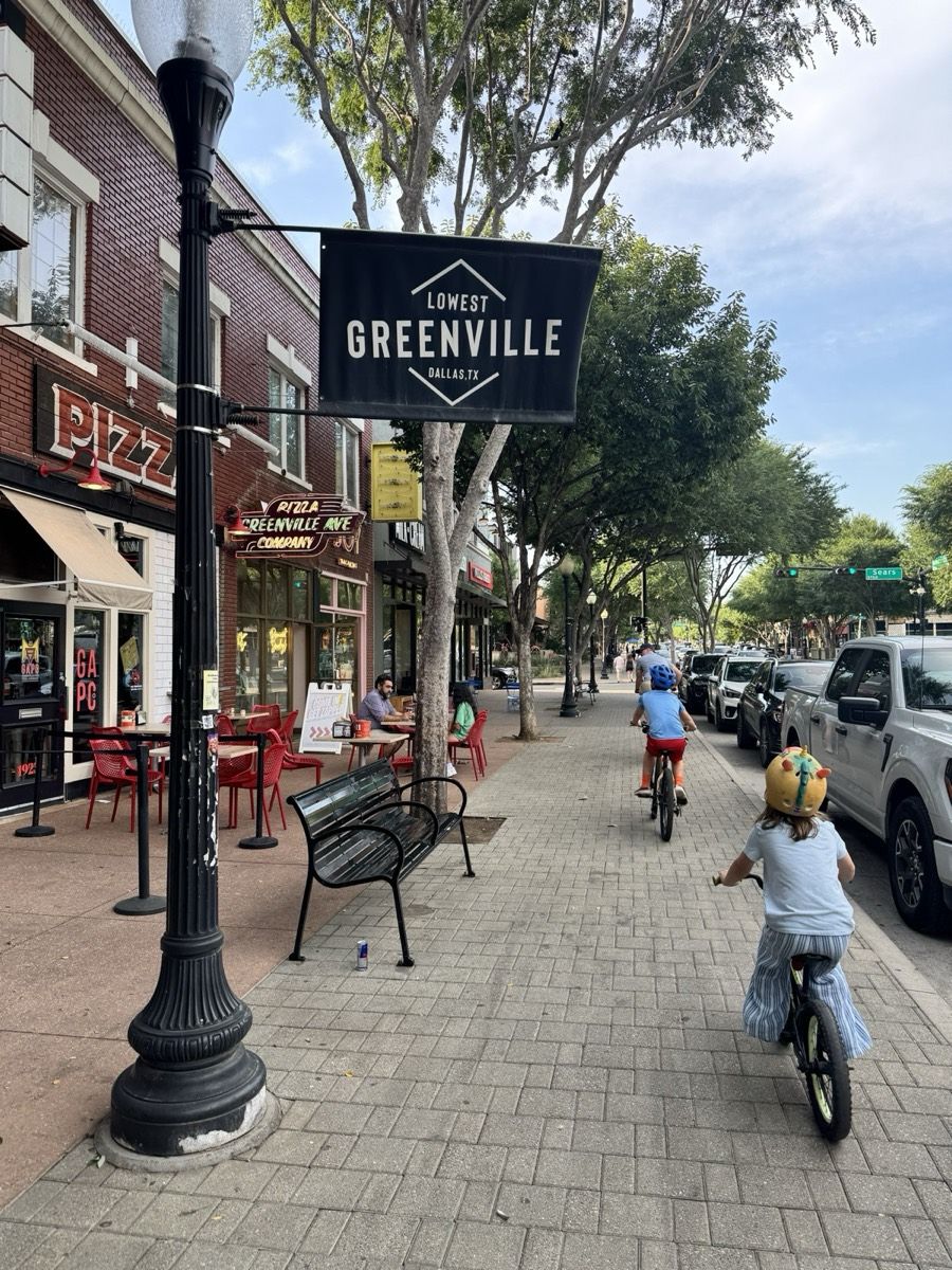 Kids biking down Greenville Avenue in Lowest Greenville